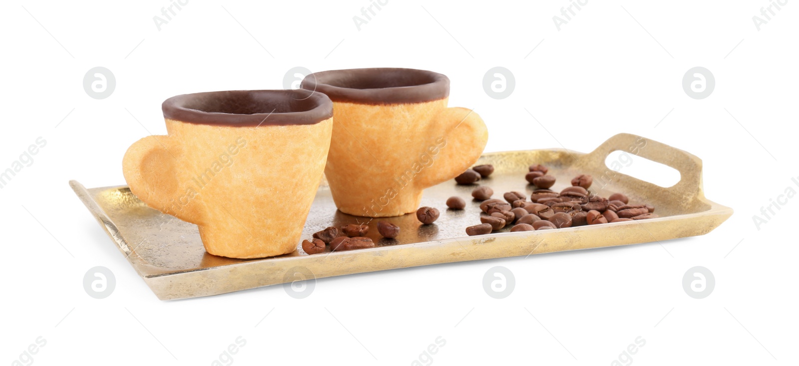 Photo of Tray with edible espresso cookie cups and roasted beans isolated on white