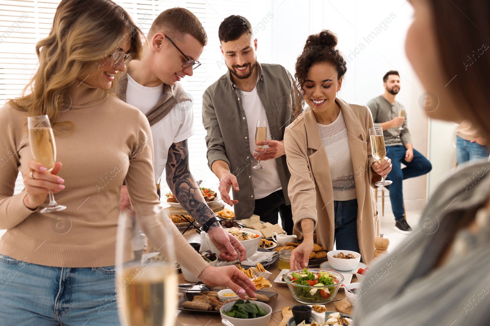 Photo of Group of people enjoying brunch buffet together indoors