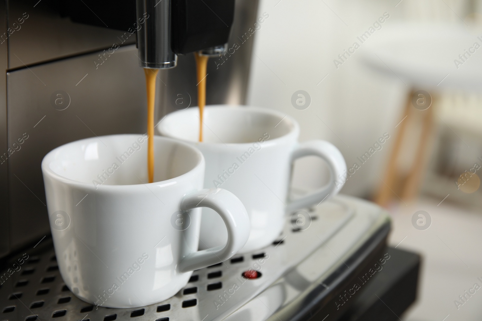 Photo of Espresso machine pouring coffee into cups against blurred background, closeup. Space for text