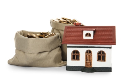 Photo of House model with money on white background
