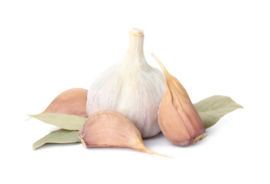 Photo of Fresh garlic bulb and cloves with bay leaves isolated on white. Organic food