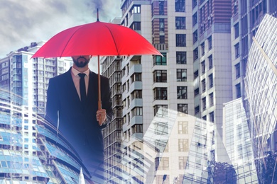 Image of Businessman with umbrella in city center. Insurance concept