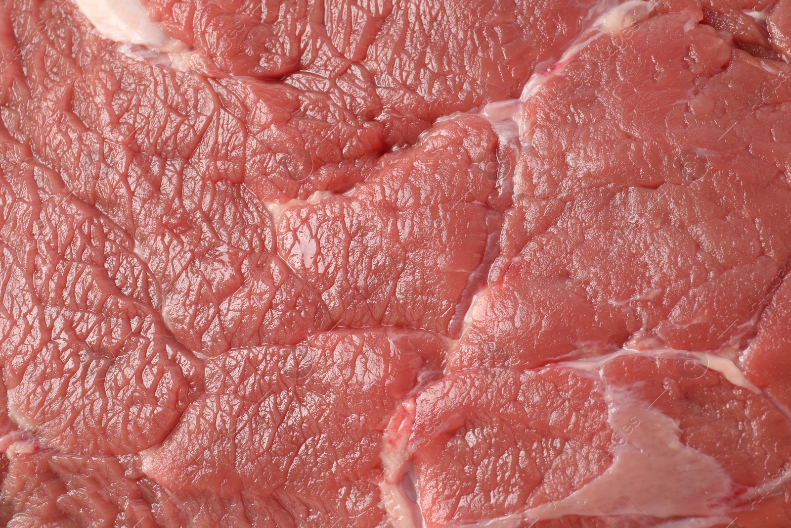 Photo of Piece of raw beef meat as background, closeup