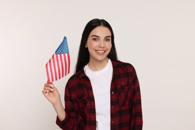 4th of July - Independence Day of USA. Happy woman with American flag on white background