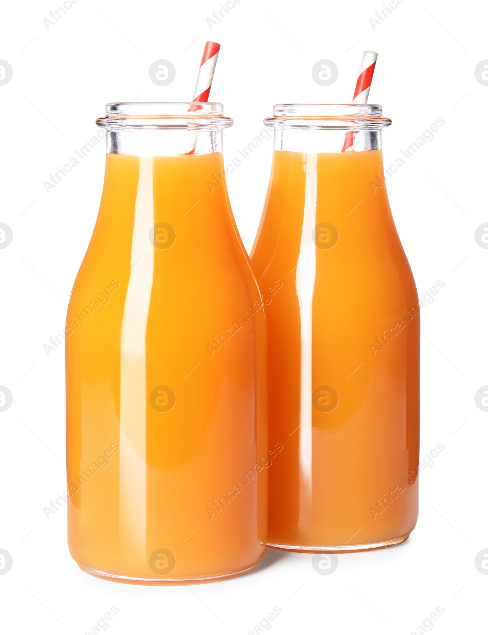 Photo of Fresh carrot juice in glass bottles on white background