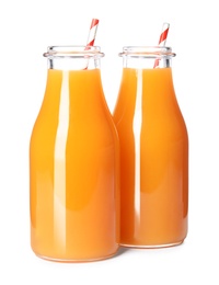 Photo of Fresh carrot juice in glass bottles on white background