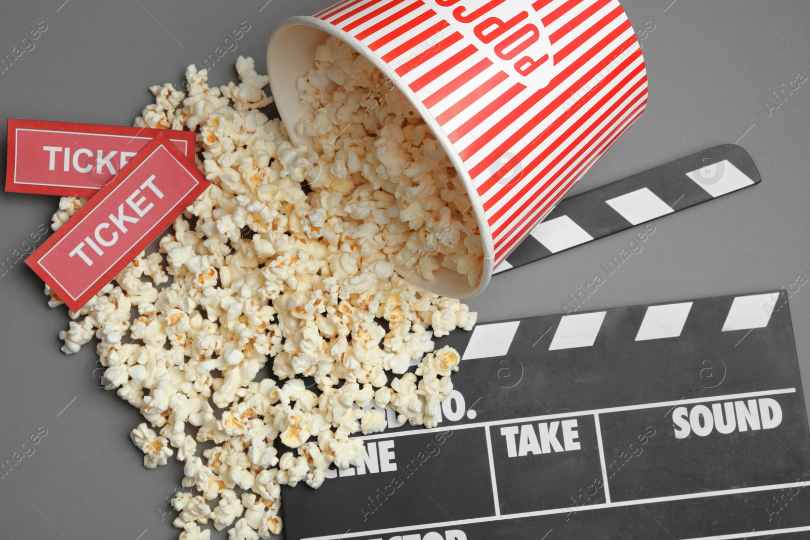 Photo of Flat lay composition with popcorn and cinema tickets on grey background