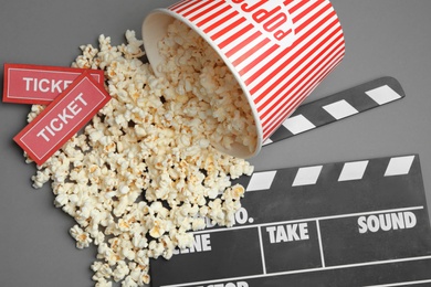 Photo of Flat lay composition with popcorn and cinema tickets on grey background