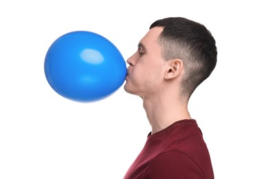 Photo of Young man inflating light blue balloon on white background