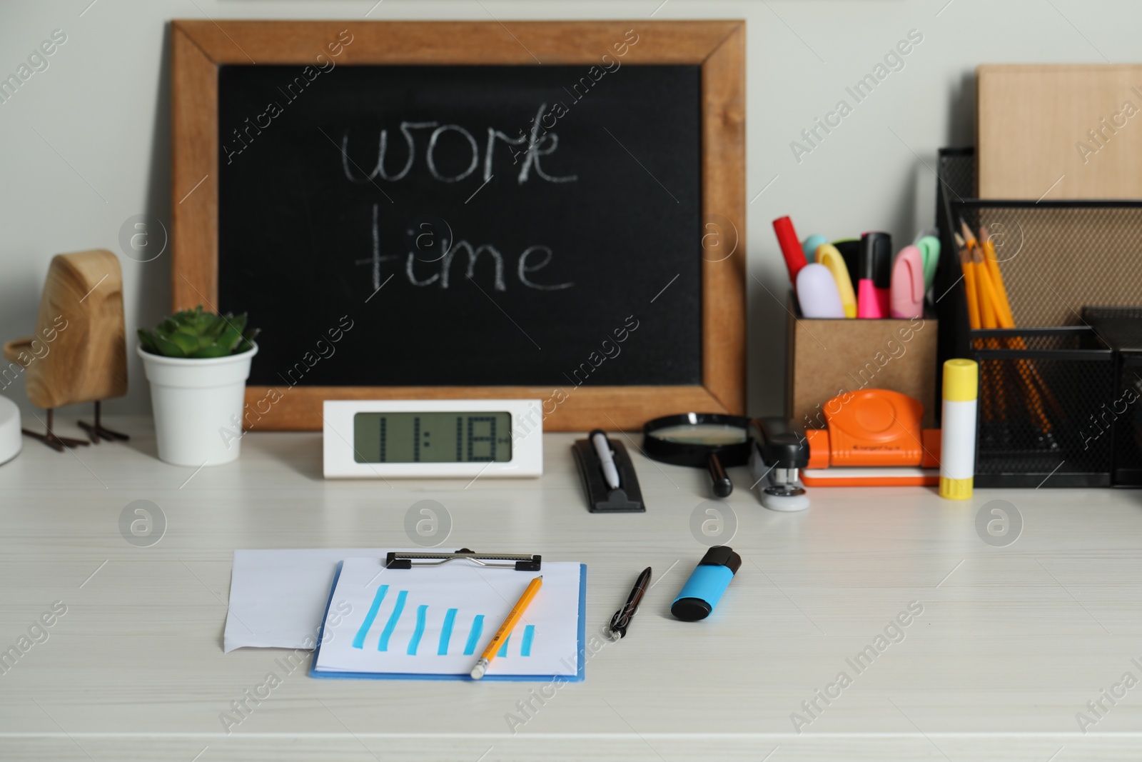 Photo of Business process planning and optimization. Workplace with small blackboard and different stationery on white wooden table