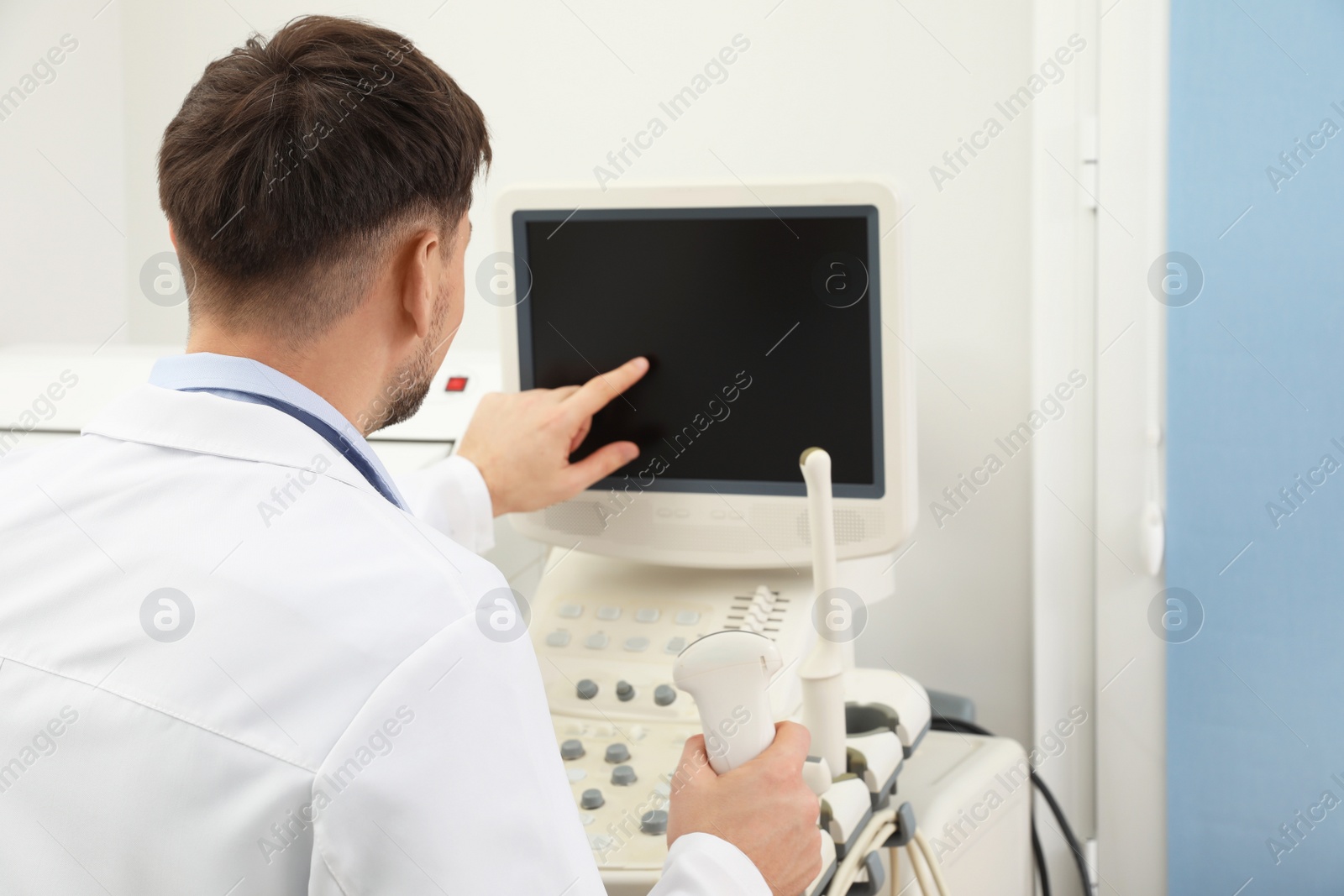 Photo of Professional sonographer using modern ultrasound machine in clinic