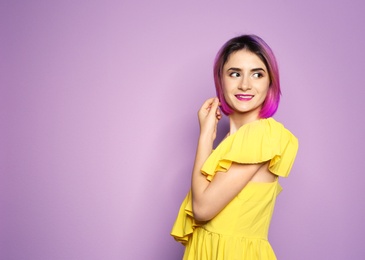 Photo of Young woman with trendy haircut against color background