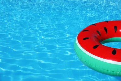 Inflatable ring floating in swimming pool on sunny day. Space for text