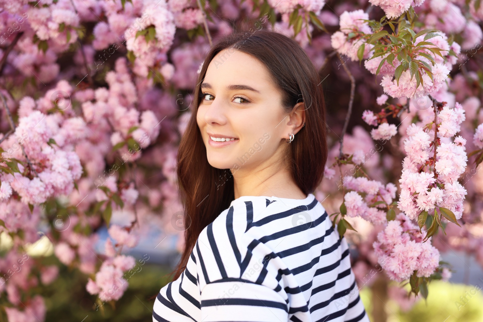 Photo of Beautiful woman near blossoming tree on spring day