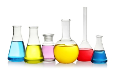 Photo of Laboratory glassware with colorful liquids on white background