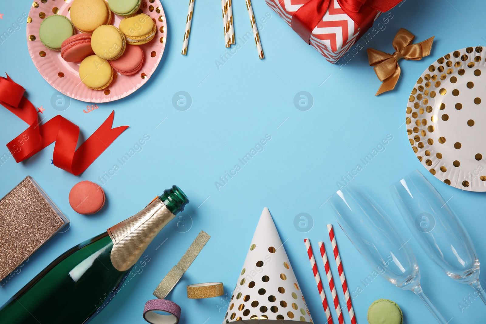 Photo of Creative flat lay composition with bottle of champagne and party accessories on color background. Space for text