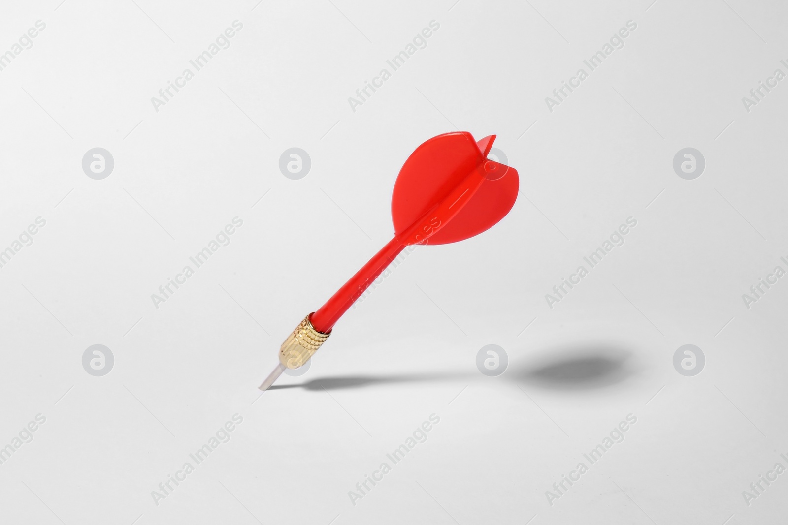 Photo of Red dart arrow for game on white background