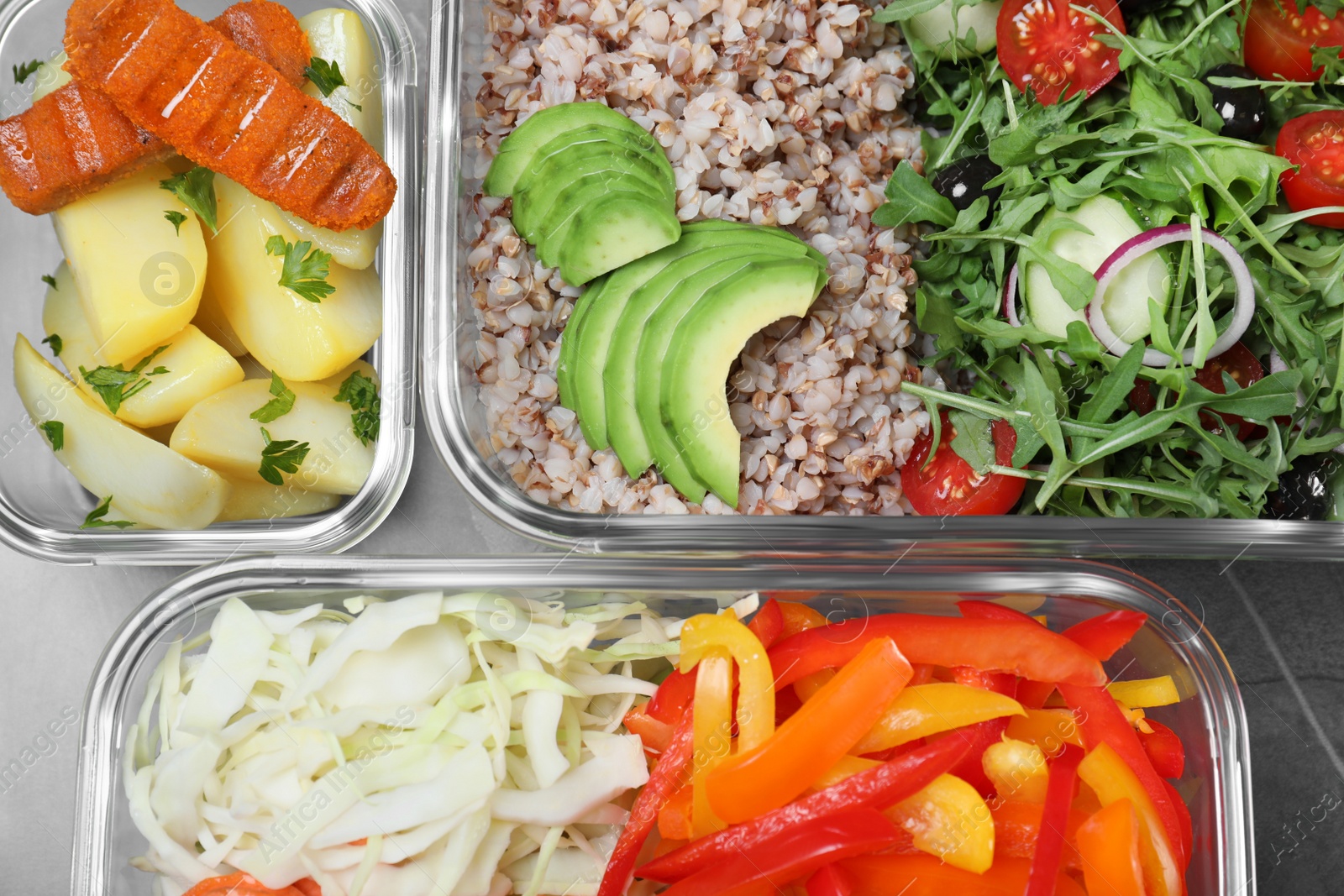 Photo of Set of glass containers with fresh food on grey table, flat lay