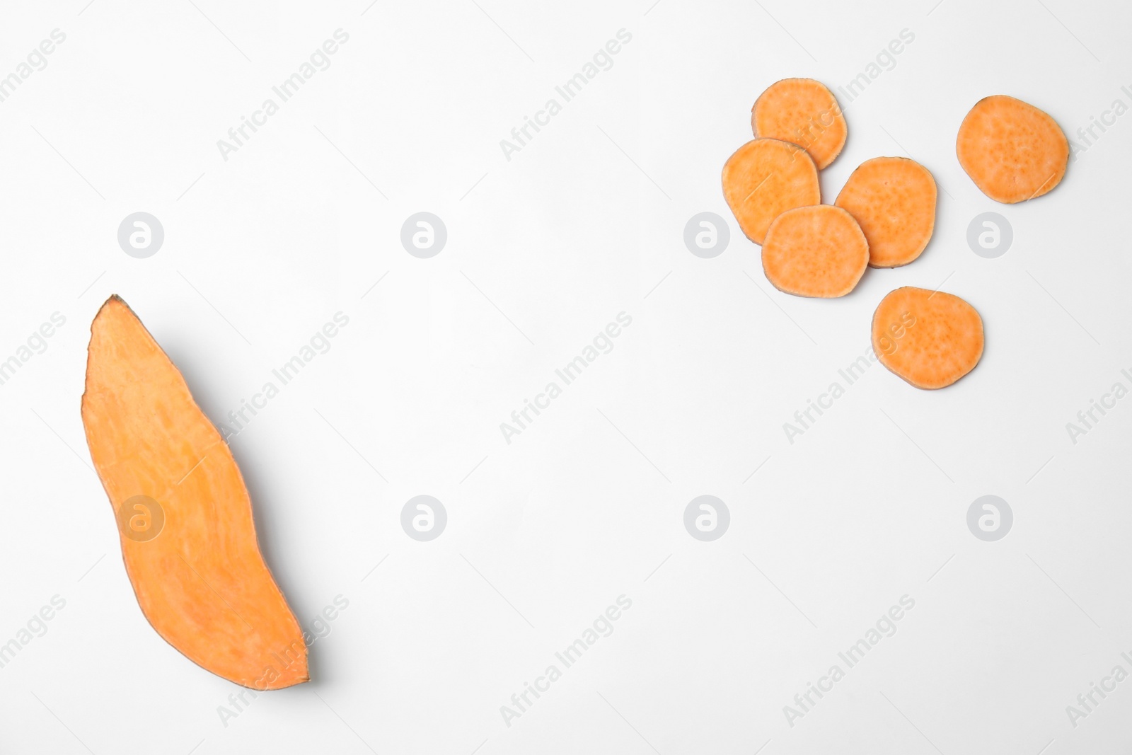 Photo of Composition with slices of sweet potatoes and space for text on white background, top view