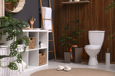 Elegant interior of modern bathroom with green plants