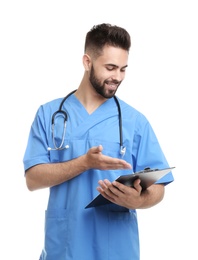 Photo of Young male doctor in uniform with clipboard isolated on white