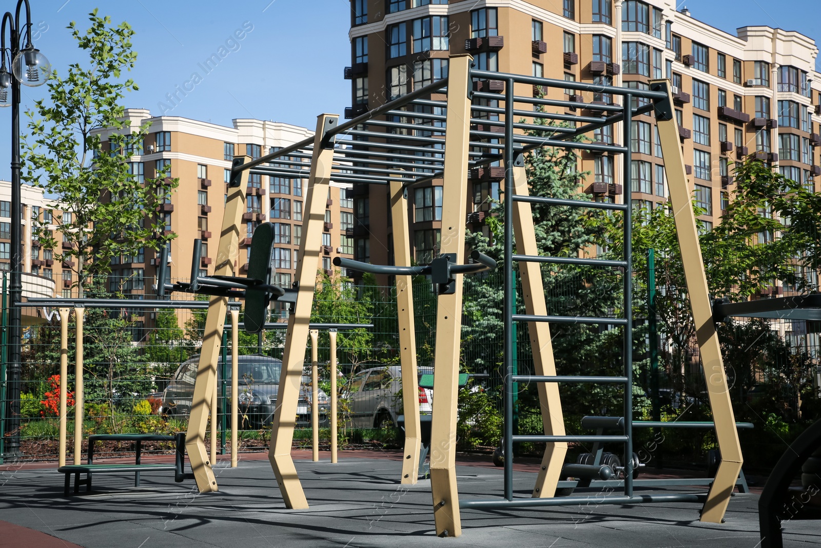 Photo of Empty outdoor gym with different sport simulators in residential area