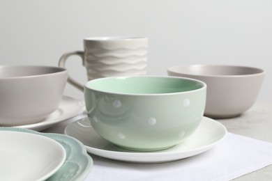 Photo of Beautiful ceramic dishware and cup on table