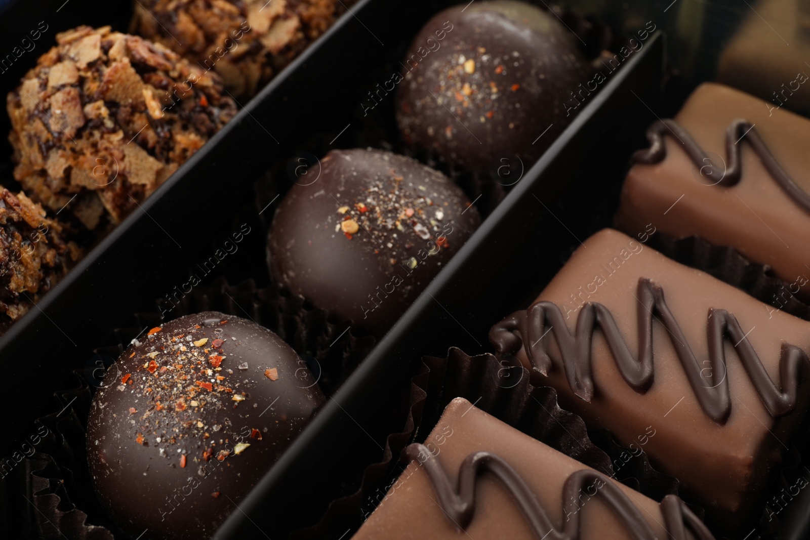 Photo of Many different chocolate candies in box, closeup