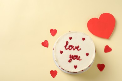 Bento cake with text Love You, paper hearts and space for text on beige table, top view. St. Valentine's day surprise