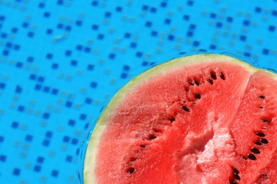 Photo of Half of fresh juicy watermelon in swimming pool, closeup. Space for text