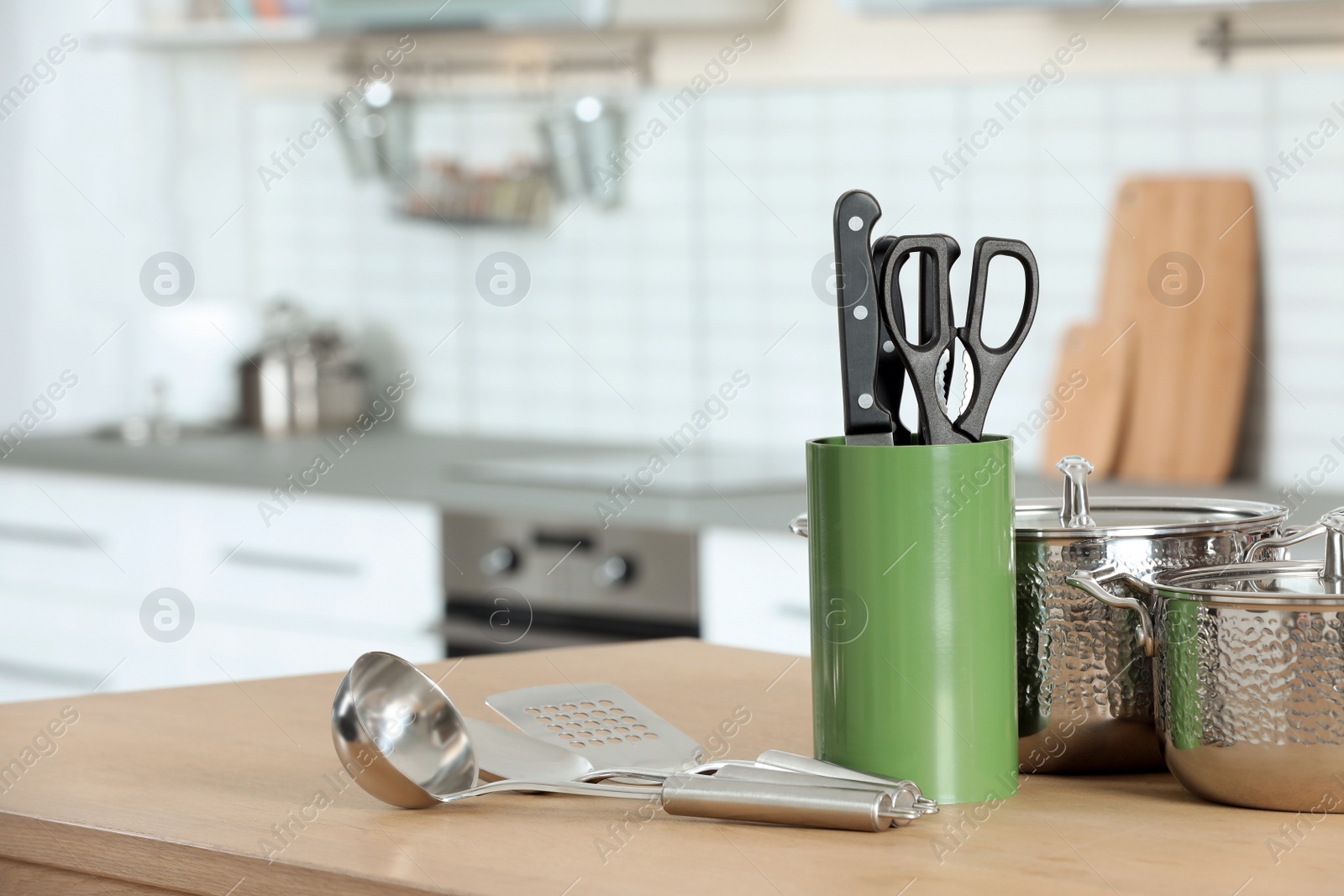 Photo of Set of clean cookware and utensils on table in kitchen. Space for text