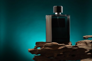 Luxury men`s perfume in bottle against color background, space for text