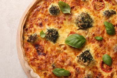 Delicious homemade vegetable quiche on light gray table, closeup