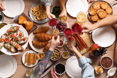 Photo of Group of people having brunch together at table, top view