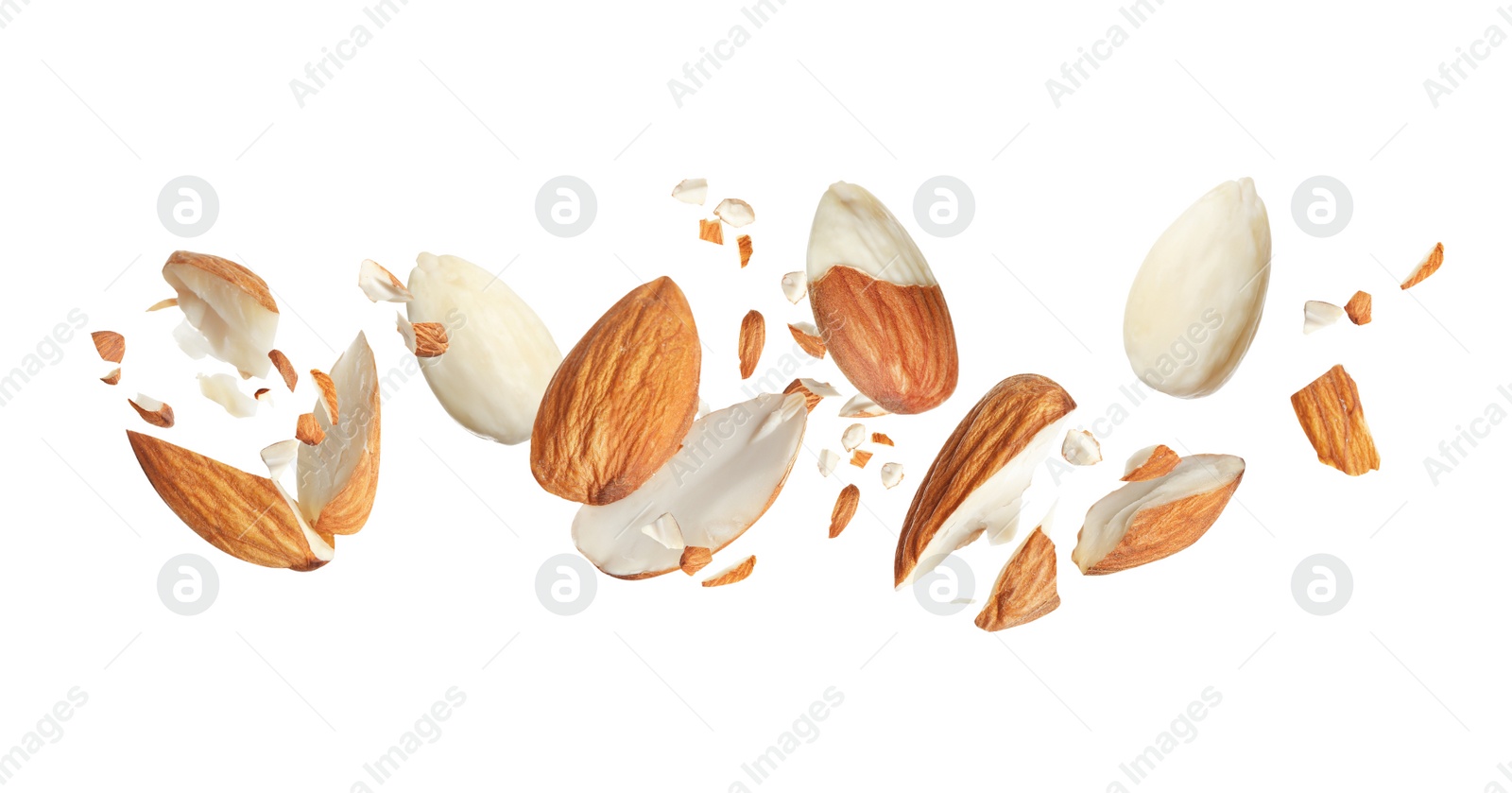 Image of Pieces of tasty almonds falling on white background. Banner design