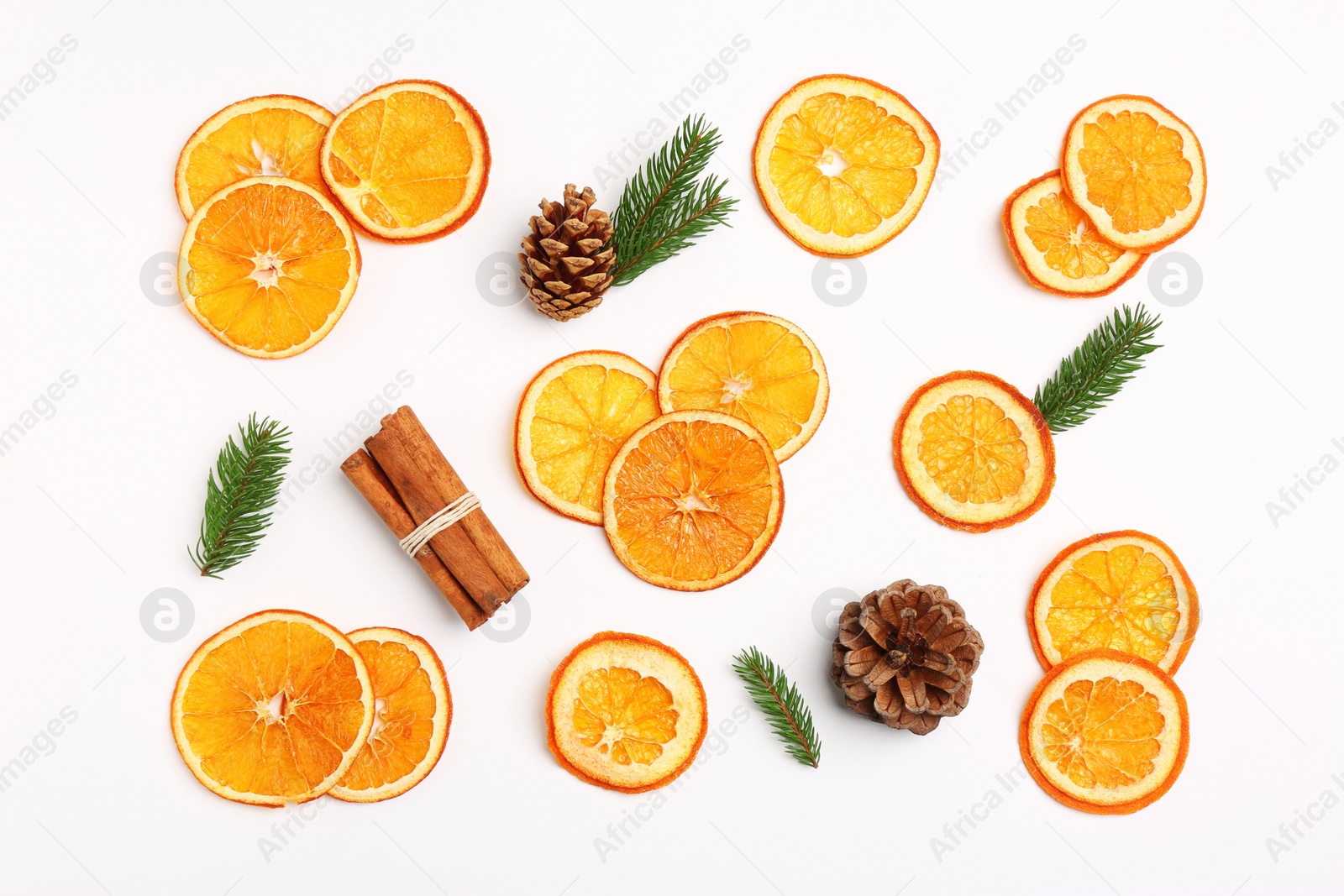 Photo of Flat lay composition with dry orange slices, fir branches, cones and cinnamon sticks on white background