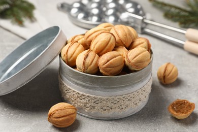 Delicious nut shaped cookies with boiled condensed milk on light grey table