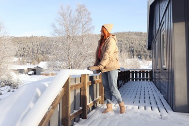 Happy young woman on terrace outdoors. Winter vacation