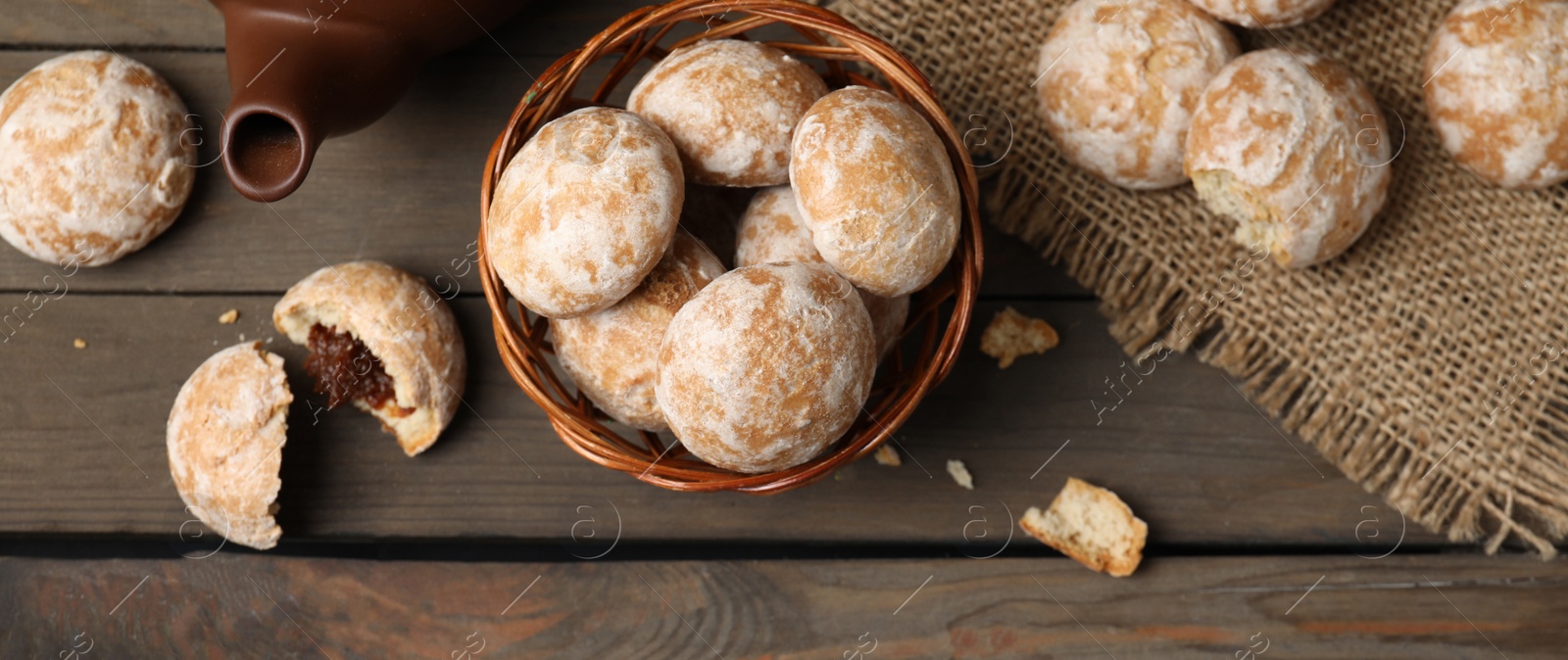 Image of Tasty homemade gingerbread cookies on wooden table, flat lay. Banner design