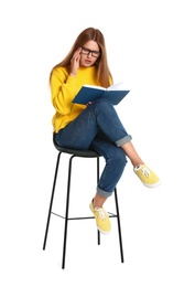 Beautiful young woman reading book on white background