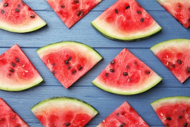 Photo of Flat lay composition with watermelon slices on wooden background