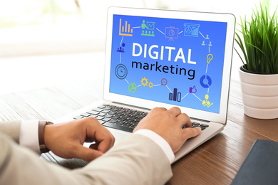 Image of Digital marketing concept. Man using modern laptop at table