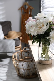 Photo of Bouquet of beautiful peony flowers on window sill indoors