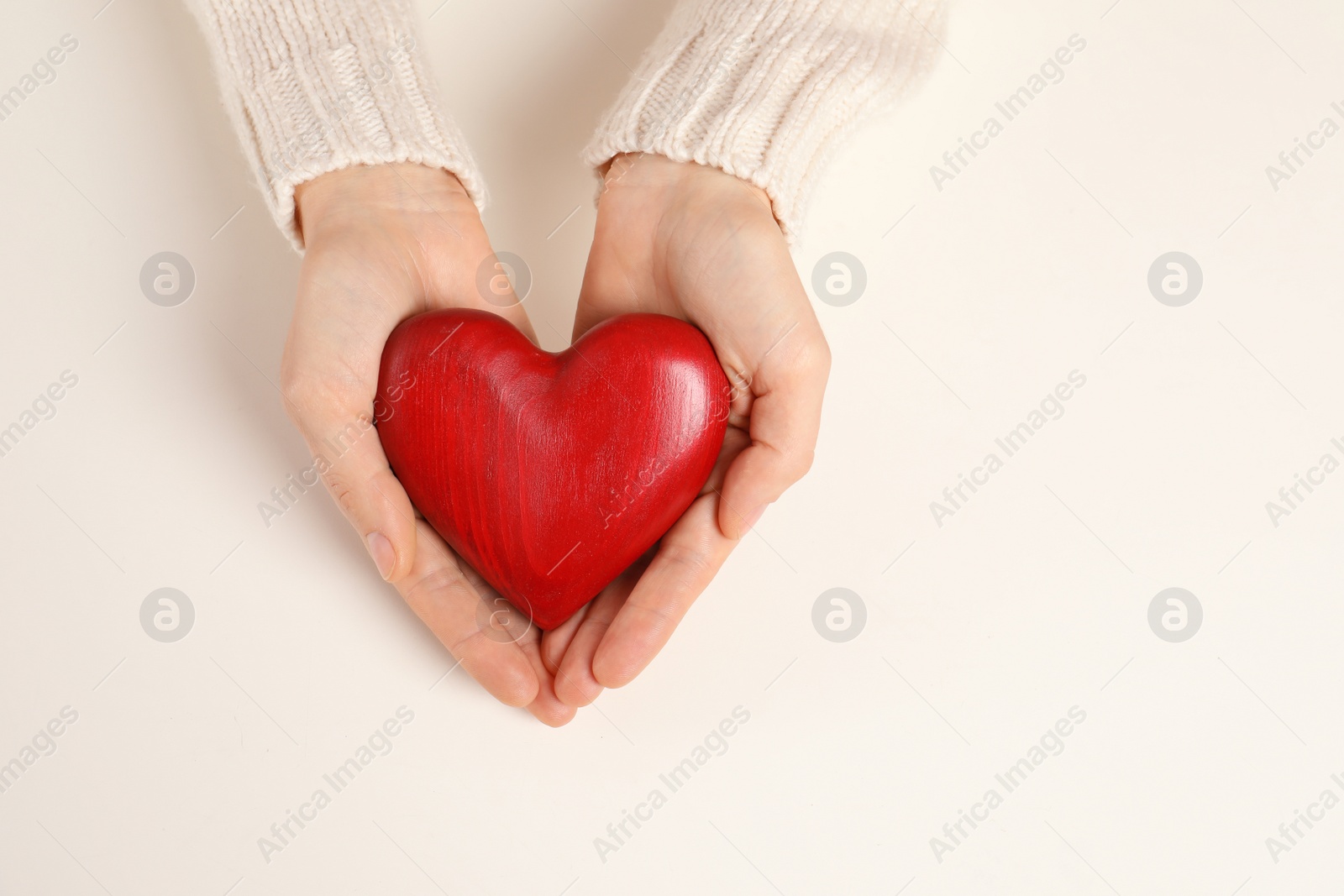 Photo of Woman holding decorative heart on white background, top view with space for text