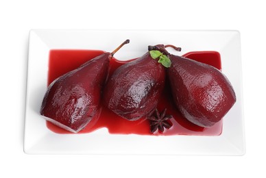 Tasty red wine poached pears with mint and anise isolated on white, top view
