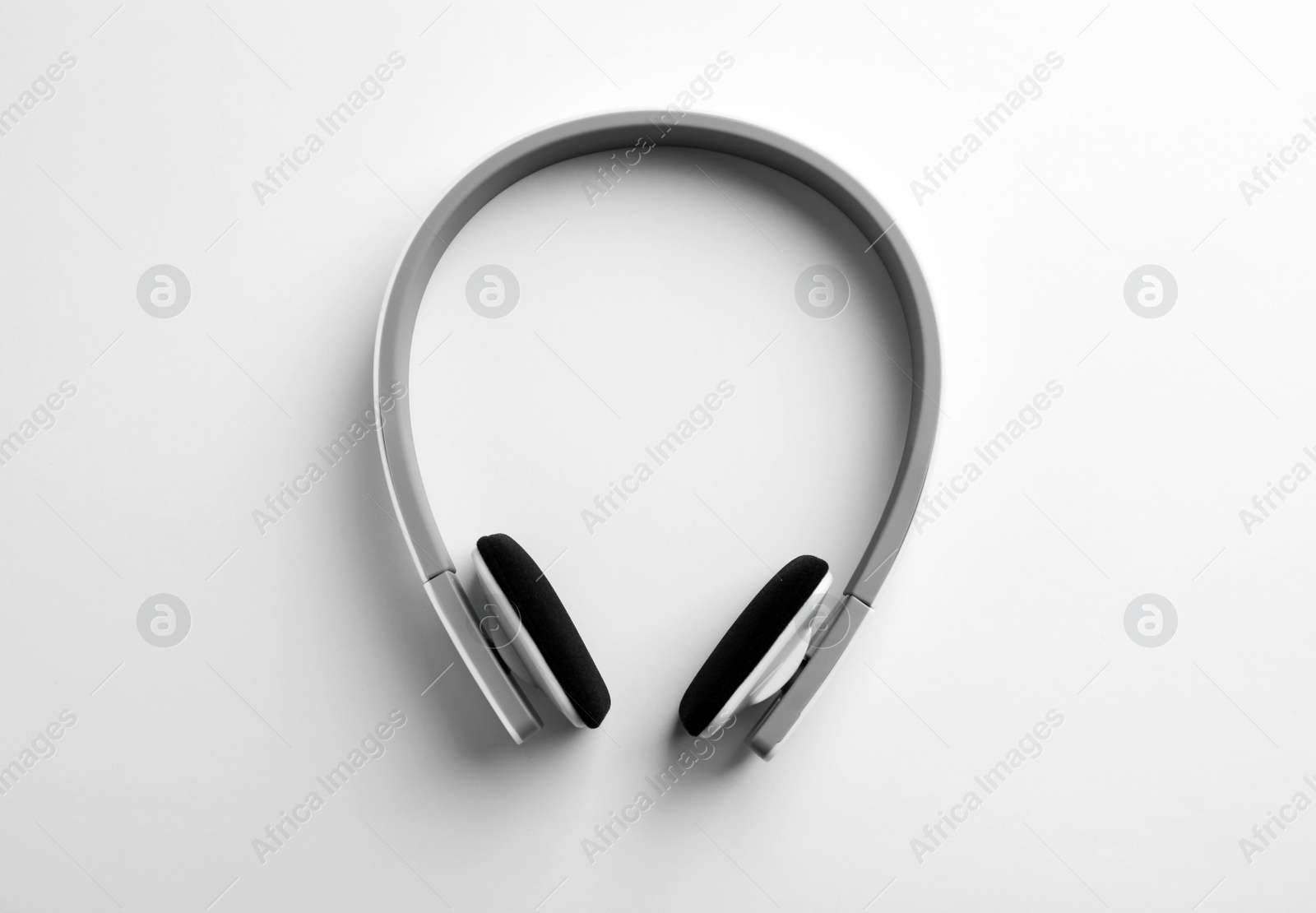 Photo of Stylish modern headphones with earmuffs on white background