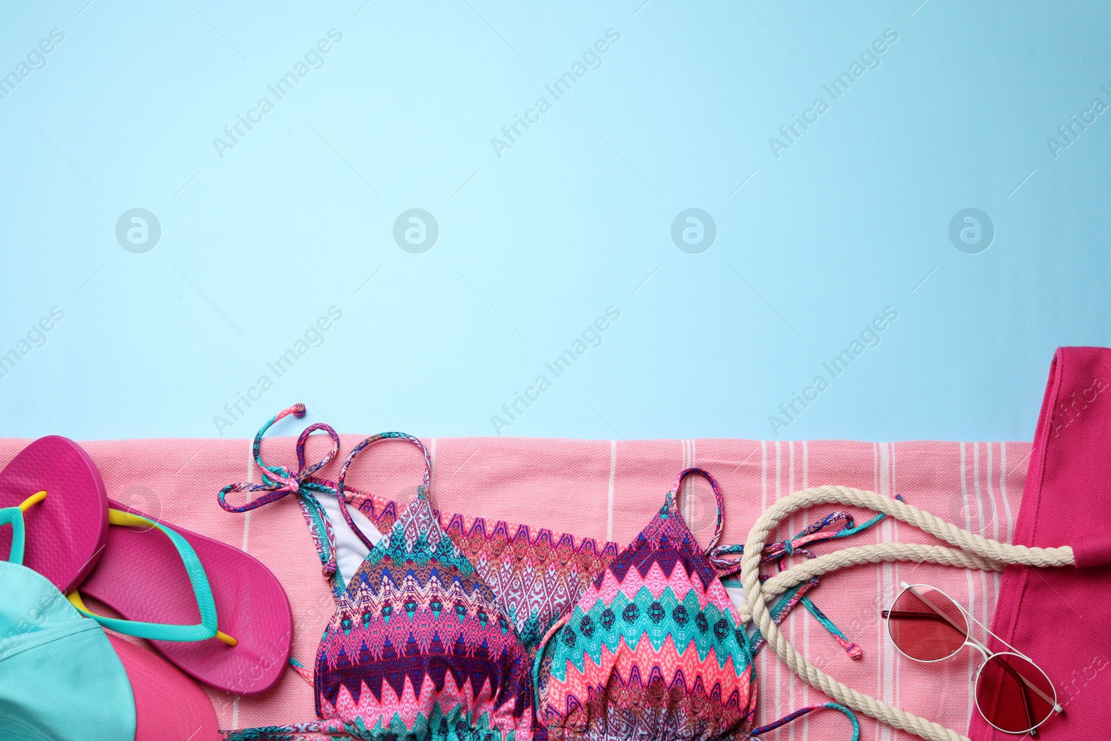 Photo of Flat lay composition with beach accessories on color background. Space for text