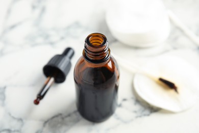 Bottle of medical iodine on white table, closeup