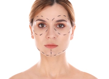 Portrait of woman with marks on face for cosmetic surgery operation against white background