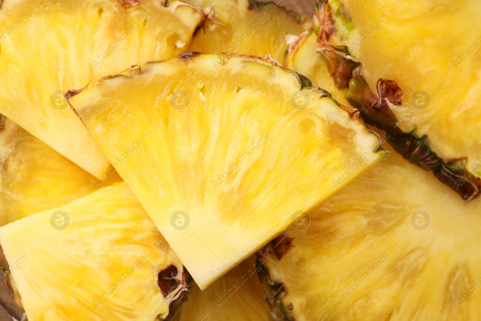 Photo of Pieces of tasty ripe pineapple as background, top view